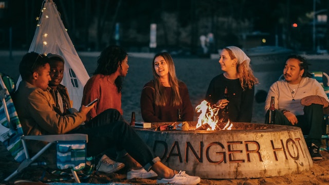 Friends sitting by a campfire